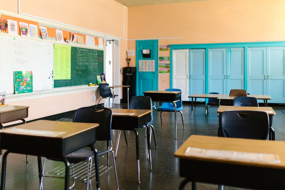 Bright and colorful empty classroom with desks, blackboard, and educational materials